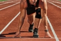 Athletic man starting evening jogging in sun rays