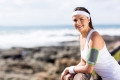 beautiful exercise woman outdoors on beach looking at the camera