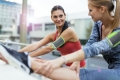 Two women stretching muscle before jogging